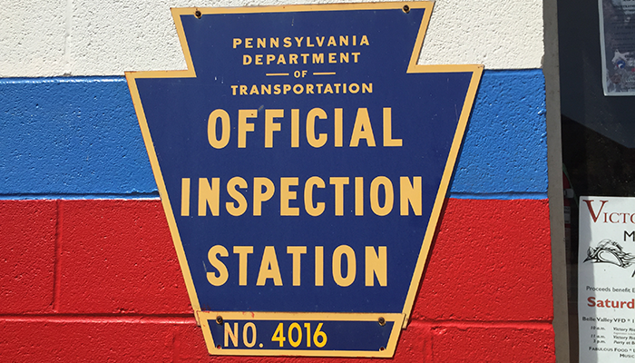 Official PA Inspection Station sign on the building at Dias Auto Service 364 West 12th Street in Erie, PA.